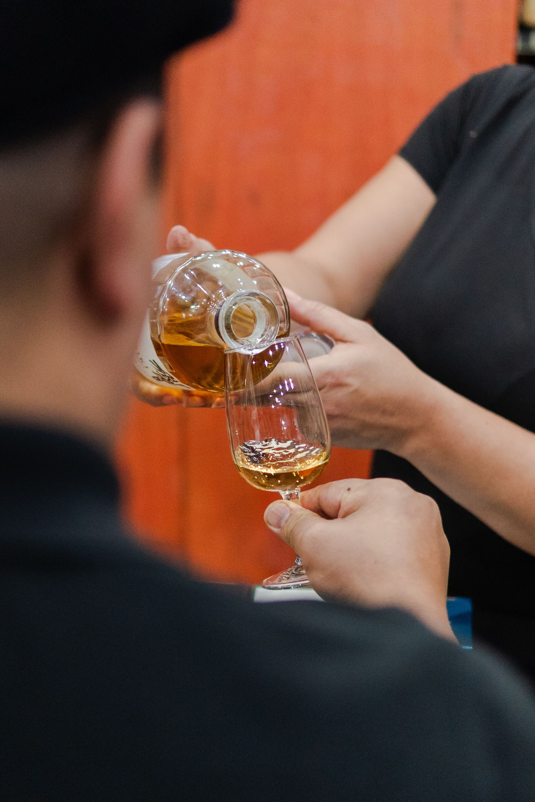 A bartender pouring whisky during a guided tasting